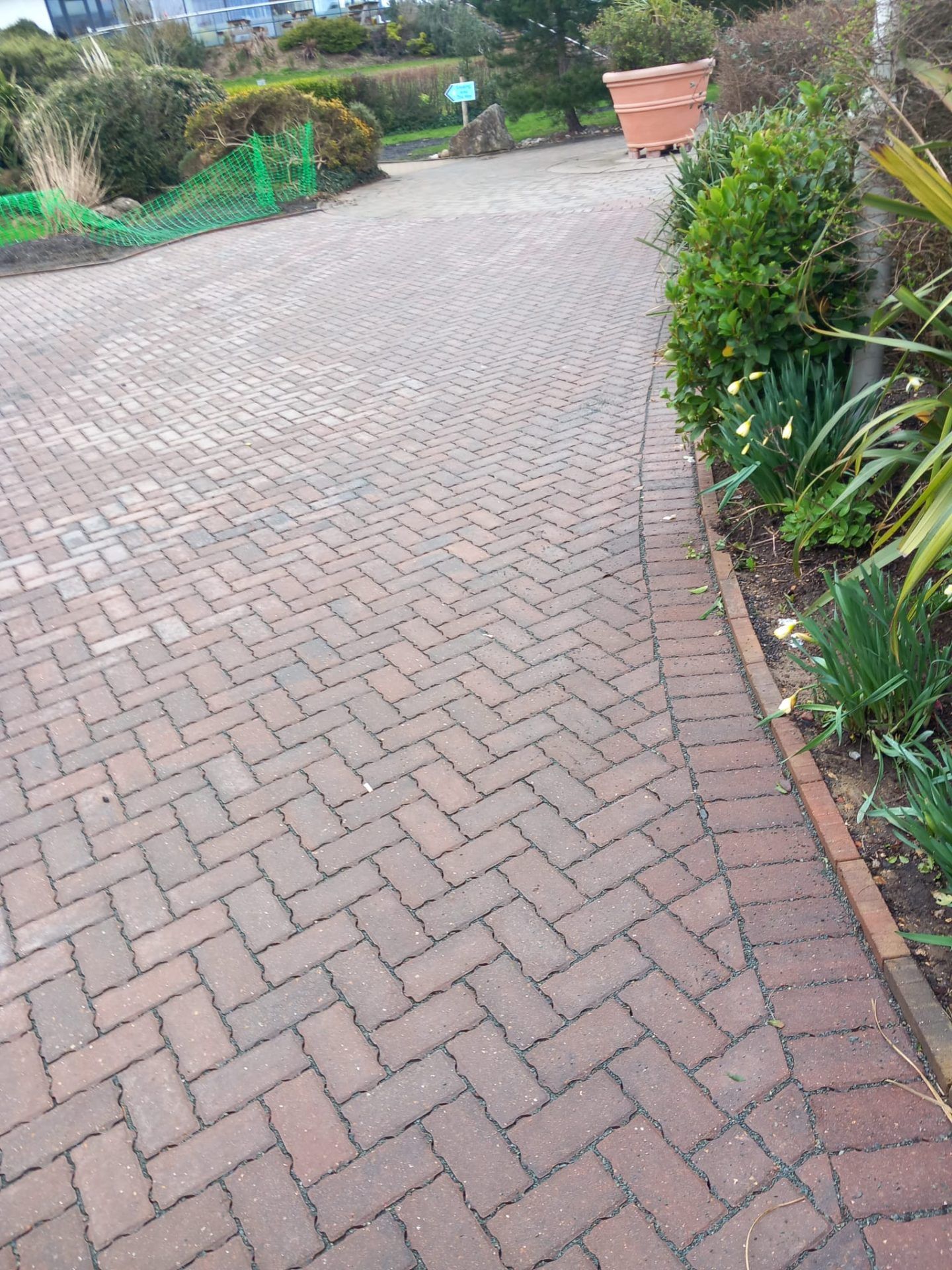 New block paving alongside flower beds.
