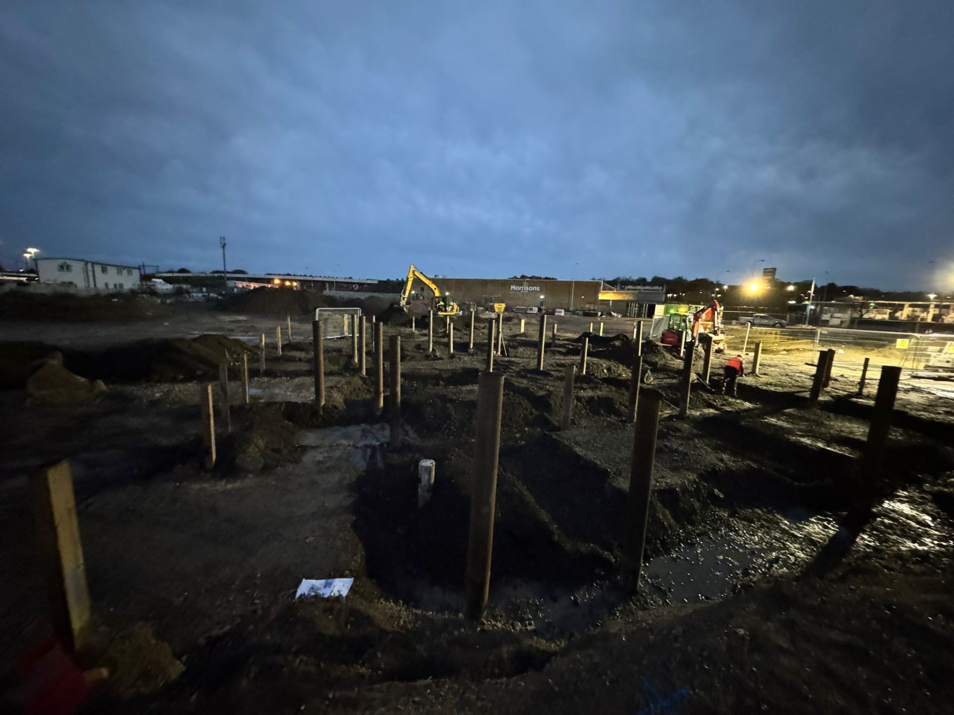Evening view of building site with excavated groundworks.